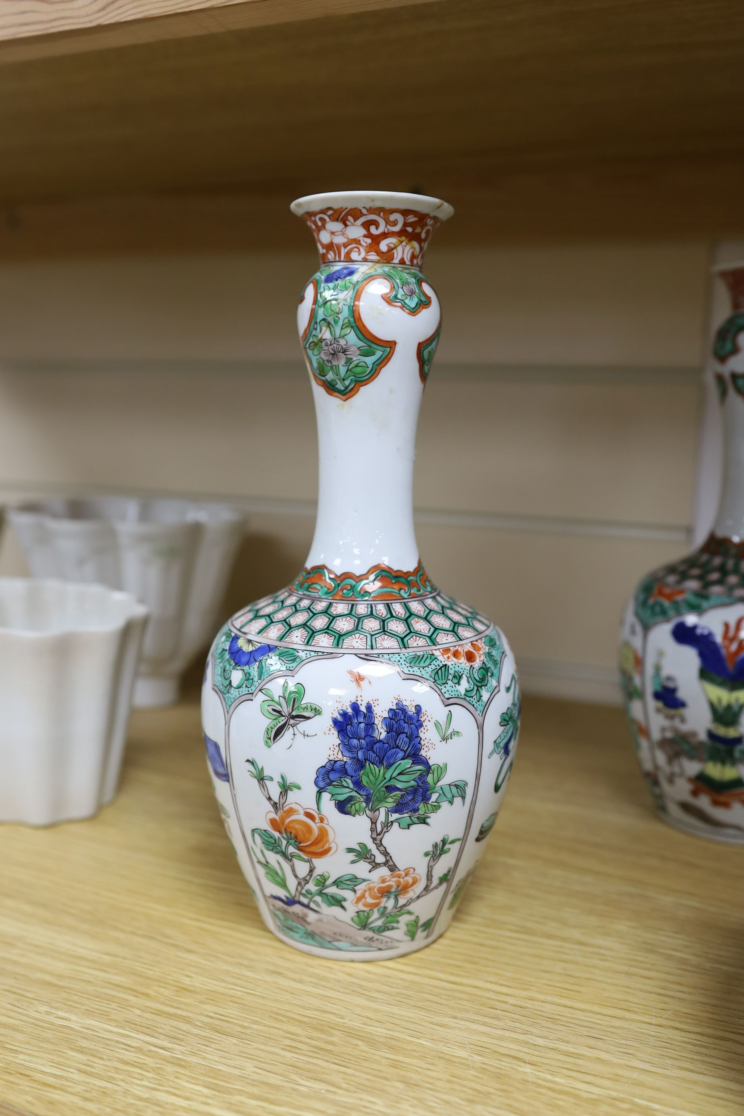 A pair Samson of Paris vases in the Chinese famille verte style and a Chinese Qianlong famille rose garlic neck vase with blue panelling motif, tallest 26cm